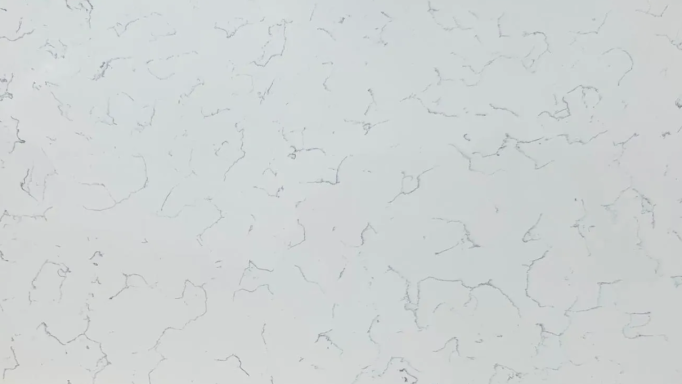 Textured white surface with subtle variations and faint patterns.