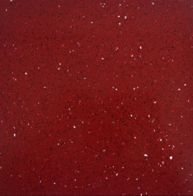 Red textured surface with scattered white specks.
